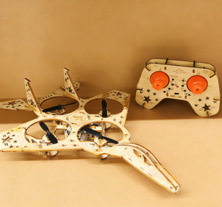 A wooden drone building kit by Arenzza with assembled drone components and tools for DIY electronics projects.
