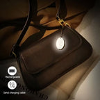 Arenzza LED touch sensor bag light, electronic accessory, illuminated with touch control, designed to attach to bags for visibility.