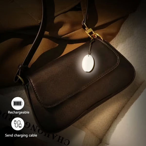 Arenzza LED touch sensor bag light, electronic accessory, illuminated with touch control, designed to attach to bags for visibility.