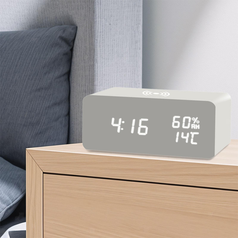 Arenzza LED digital alarm clock with wireless charging station, displaying time on a sleek black electronic device