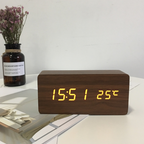 Arenzza LED digital alarm clock with wireless charging station, showing time display and charging pad on a sleek electronic device.