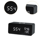 Arenzza LED digital alarm clock with wireless charging station, showing time display, sleek black design, and charging pad on top.
