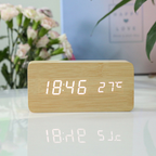 Arenzza LED digital alarm clock with wireless charging station, showing time display and sleek electronic design.