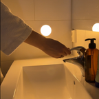 Arenzza LED motion sensor light in a bathroom, showcasing energy-efficient illumination with a sleek design and motion detection features.
