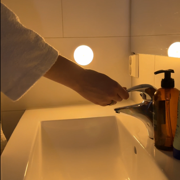 Arenzza LED motion sensor light in a bathroom, showcasing energy-efficient illumination with a sleek design and motion detection features.
