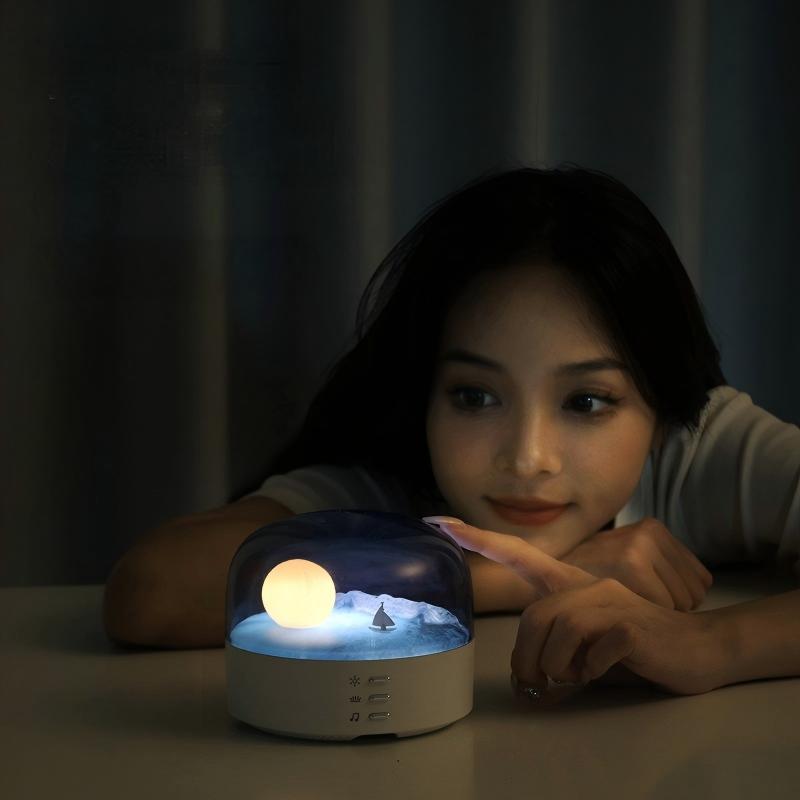 Arenzza Moon Sea Landscape LED Night Light and Bluetooth Speaker showing a night sky with moon and ocean scene in a compact electronic device.