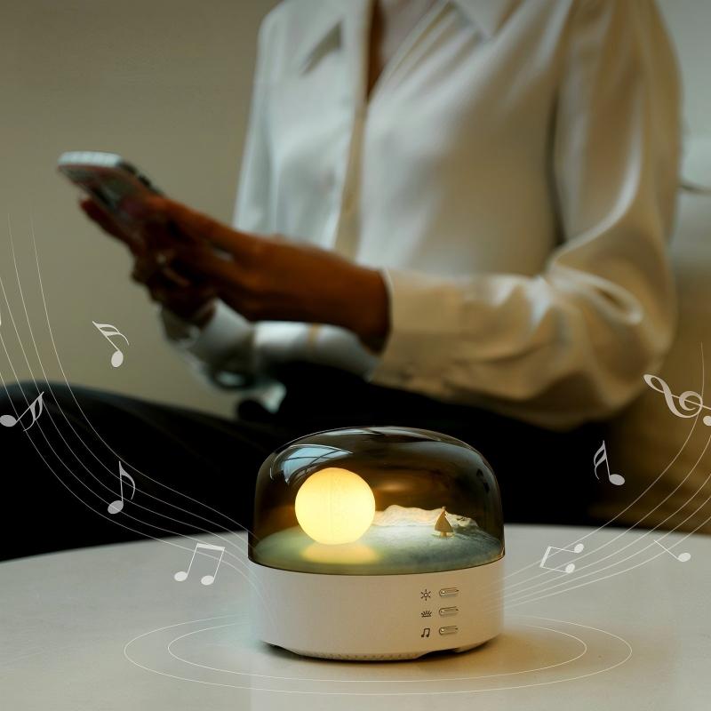 Arenzza Moon Sea Landscape LED night light speaker with a scenic moon and ocean design, compact electronic device with controls visible.