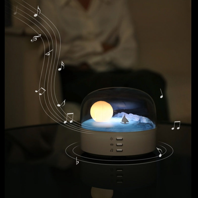 Arenzza Moon Sea Landscape LED Night Light Speaker showing a scenic moon and ocean design with built-in speaker in a black base