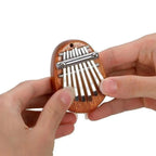 Arenzza Palm Finger Piano toy, compact musical instrument for kids, featuring colorful keys and playful design for entertainment.