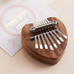 Arenzza Palm Finger Piano toy, compact handheld musical instrument with colorful keys, ideal for fun music practice and entertainment.