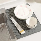 Arenzza QuickDry™ sloped silicone mat with drainage holes for quick water runoff, ideal for kitchen or bathroom use.