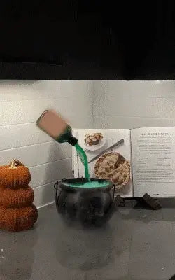 Aarenza Halloween indoor decoration featuring a witches' cauldron with floating potion bottles and fog effects.