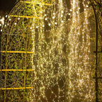 A bunch of waterproof Christmas LED firefly twinkle lights from Arenzza with warm white glowing bulbs for holiday decor.
