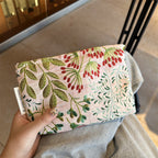 Elegant floral printed cosmetic bag by Arenzza with colorful floral patterns, compact and stylish for beauty essentials storage.