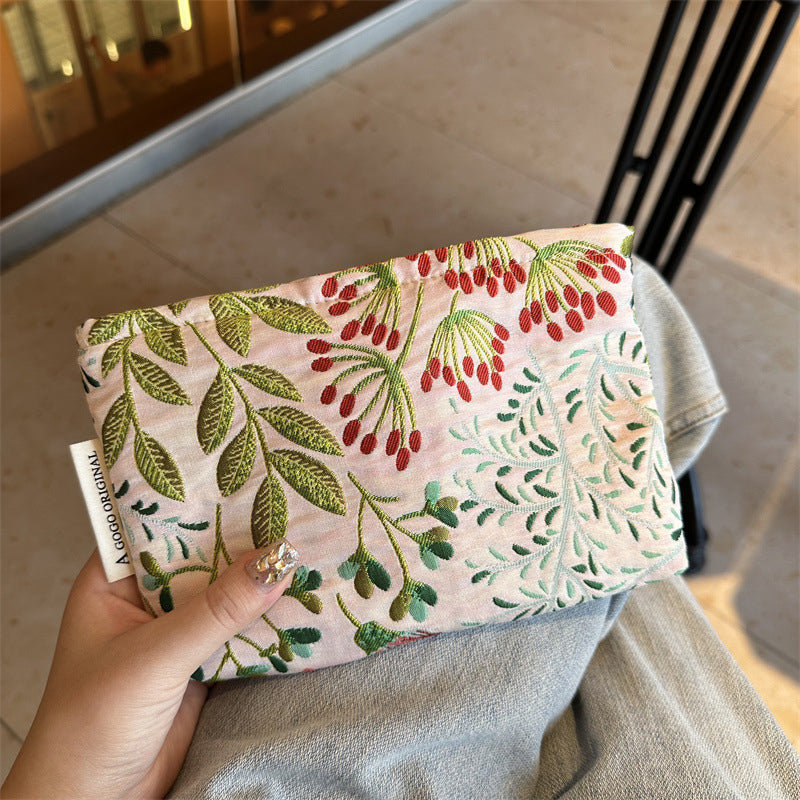 Elegant floral printed cosmetic bag by Arenzza with colorful floral patterns, compact and stylish for beauty essentials storage.
