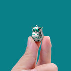 Mini foldable stainless steel owl nail clippers by Arenzza, compact and portable for easy nail trimming and grooming.