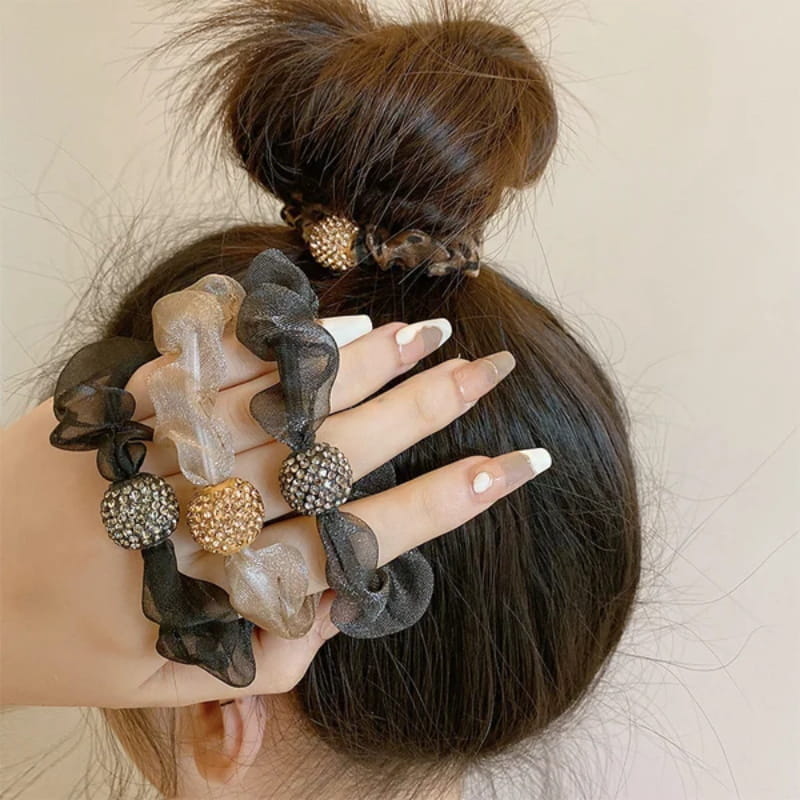 Arenzza elegant rhinestone mesh hair ties in purple with shimmering rhinestones, styled into a bun for a glamorous look.