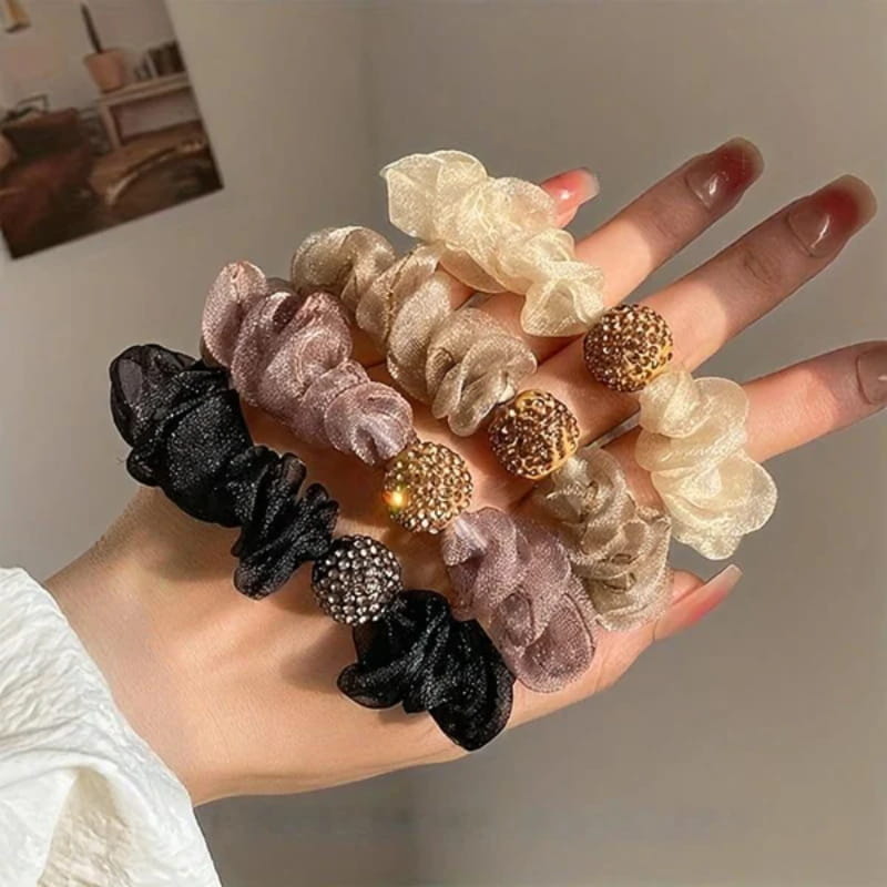 Arenzza elegant rhinestone mesh hair ties with purple accents, styled on a model's hair for a glamorous, fashionable look.