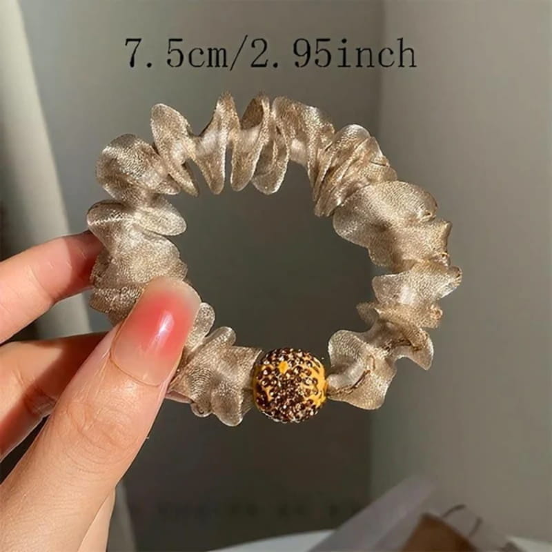 A pair of Arenzza elegant rhinestone mesh hair ties with purple accents, perfect for stylish hair accessories.