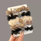 A pair of elegant purple rhinestone mesh hair ties by Arenzza, featuring sparkling details and elastic bands for stylish hair accessories.