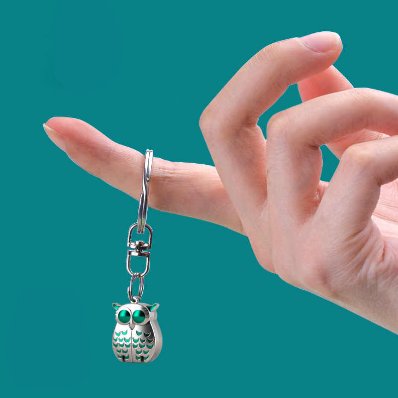 Mini foldable stainless steel owl clipper by Arenzza, shown in a closed compact design with detailed owl features.