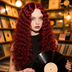 A woman wearing a long, curly Arenzza women's wig with voluminous dark hair, showcasing health and beauty fashion style.