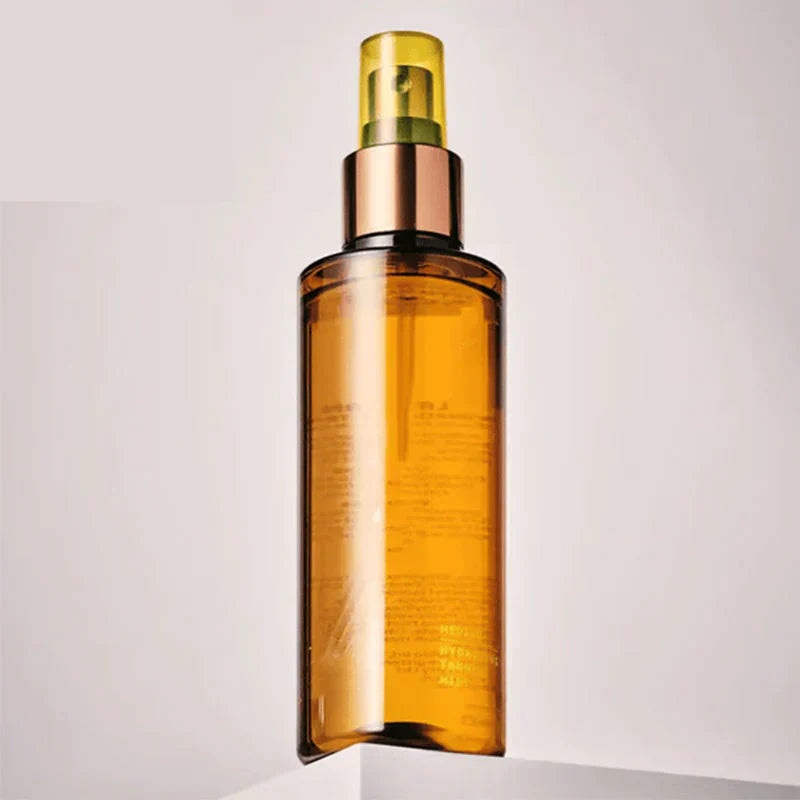 Arenzza hydrating self-tanning mist for a natural glow, displayed in a sleek spray bottle with a clear label.