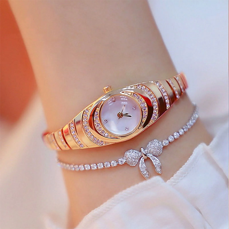 A women’s rhinestone bracelet watch by Arenzza featuring a sparkling rhinestone-studded band and a round watch face.