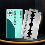 A close-up of stainless steel double-edged razor blades by Arenzza, showcasing sharp edges and polished metal surface.