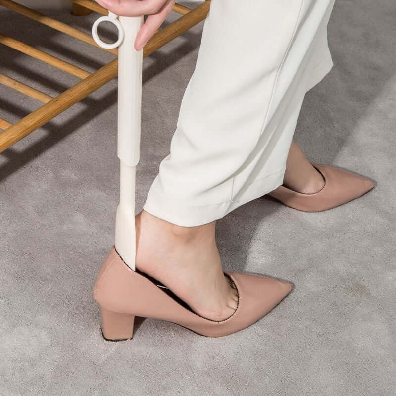 Arenzza telescopic adjustable shoe horn with extended handle for easy shoe dressing, made of durable material, in a home improvement setting.