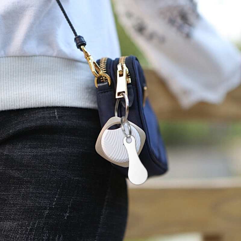 A pair of stainless steel shopping trolley token keyrings by Arenzza, featuring keyring attachments and trolley coin discs.