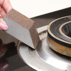 Arenzza Emery Cleaning Sponge for stubborn stains, shown in use on kitchen surface, ideal for household cleaning tasks.