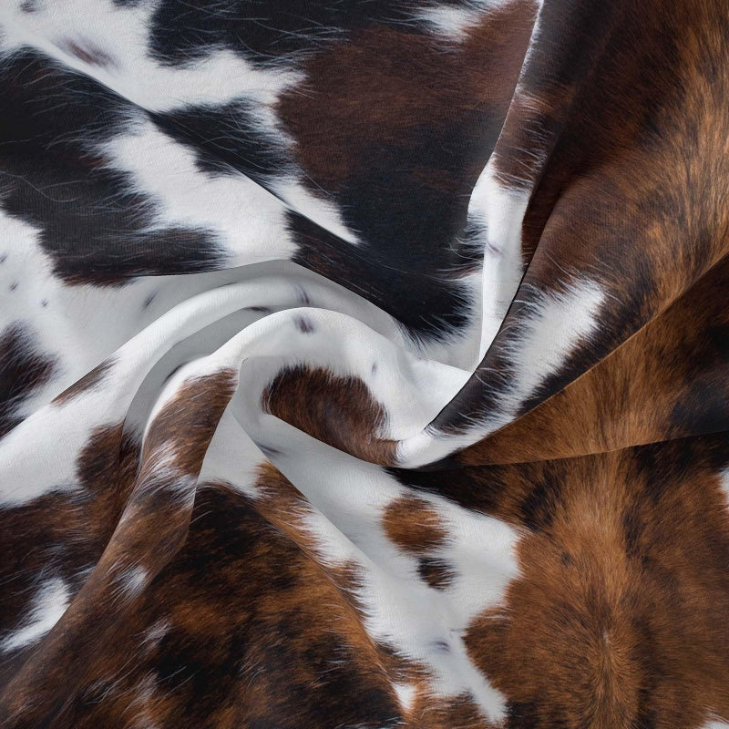 Aarenza cow print duvet cover set with soft, lightweight fabric and fun black and white cow pattern on a bed.