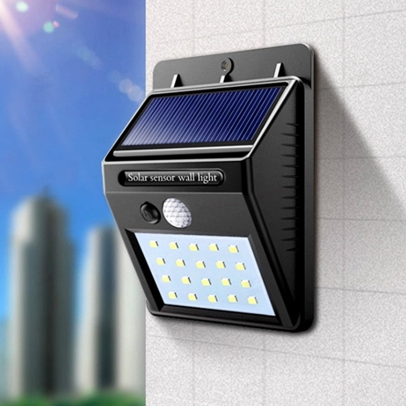 Arenzza solar powered motion sensor wall light mounted on a wall, illuminating an outdoor space with bright LED light.