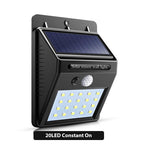 Arenzza solar powered motion sensor wall light mounted on exterior wall, with solar panel and LED light for outdoor security.