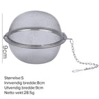 Three Arenzza 304 stainless steel spice and tea filters in a kitchen setting, showing fine mesh screens and metal construction.