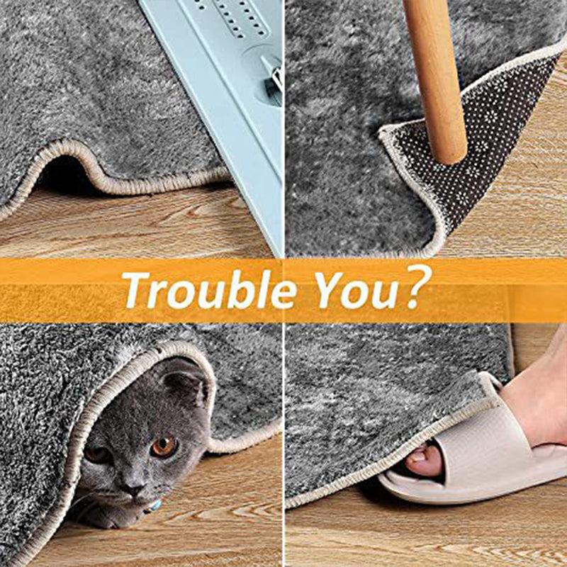 Heart-shaped Arenzza reusable non-slip rug grippers on a rug to prevent slipping in the house and kitchen.