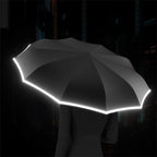 Arenzza reflective safety strip ring buckle umbrella with a black handle and reflective strip for visibility in low light conditions.