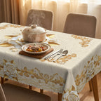 A waterproof gold rose tablecloth from Arenzza, featuring a floral design, suitable for houseware and kitchen use, on a dining table.