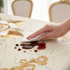 A waterproof gold rose tablecloth from Arenzza, showcasing a luxurious floral design on a kitchen table for elegant dining.