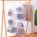 Arenzza hanging handbag dust-proof organizer with 6 large pockets for kitchen or houseware storage, hanging on a hook.