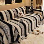 Arenzza soft plush non-slip couch cover in beige, draped over a modern sofa to protect and add comfort to living room furniture.
