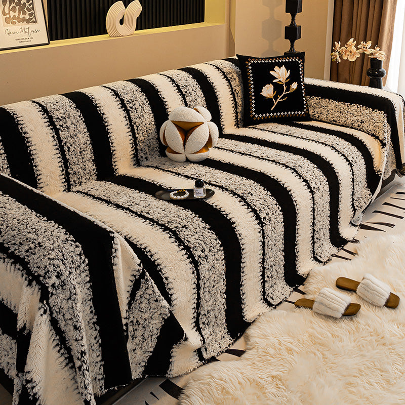 Arenzza soft plush non-slip couch cover in beige, draped over a modern sofa to protect and add comfort to living room furniture.