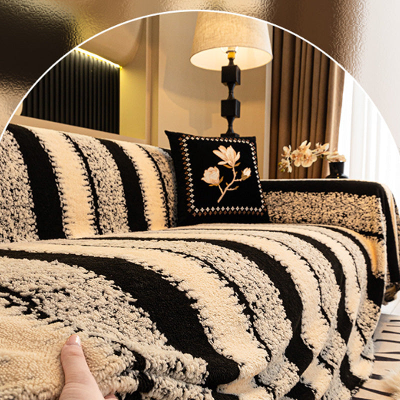 A soft plush Arenzza non-slip couch cover draped over a sofa, showcasing its cozy texture and secure fit for houseware and kitchen use.