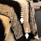 A soft plush Arenzza non-slip couch cover draped over a sofa, showing its comfortable fabric and secure fit for houseware and kitchen use.