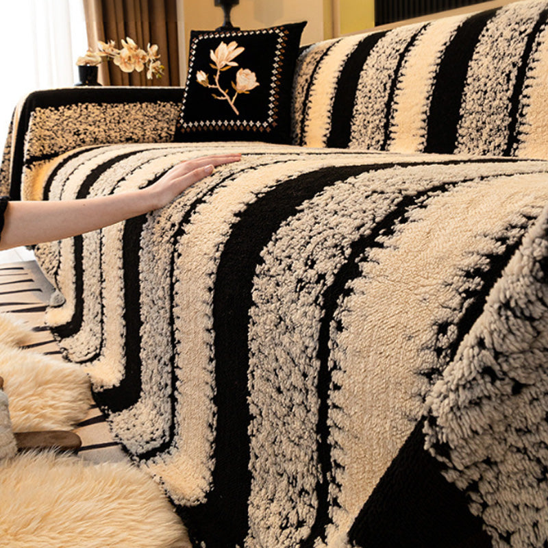 A soft plush Arenzza non-slip couch cover in beige draped over a sofa, protecting and decorating living room furniture.
