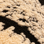 A soft plush Arenzza non-slip couch cover in a cozy, neutral color fitted over a sofa in a living room setting.