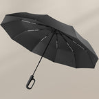 Aarenza folding sun umbrella for rain and sunshine, compact and black, with a handle and open canopy showing sun and rain symbols.