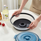 Arenzza collapsible microwave cover with base mat in use, protecting microwave from splatters in a kitchen setting.