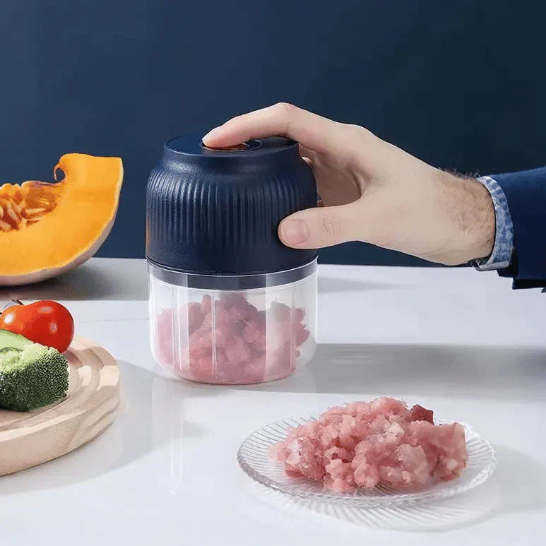 Arenzza cordless mini electric garlic chopper in use, showing its compact design and stainless steel blades for efficient garlic chopping.